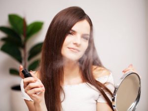 A professional make-up artist makes an evening make-up for a young woman.