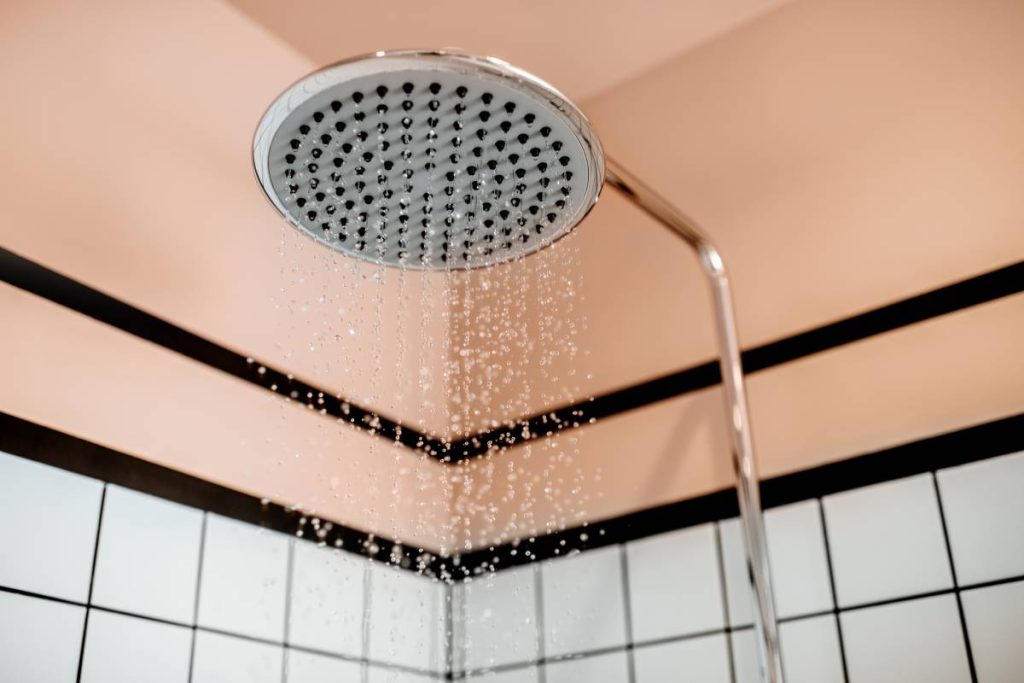 Shower with falling drops of water in the bathroom